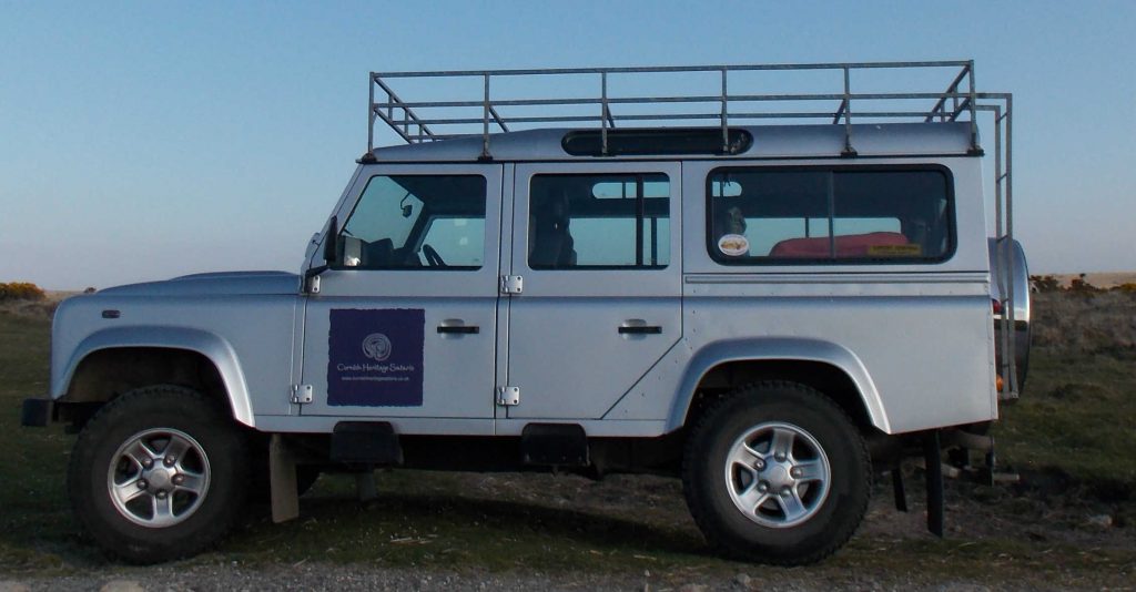 Silver Land Rover Defender with Cornish Heritage Safaris logo
